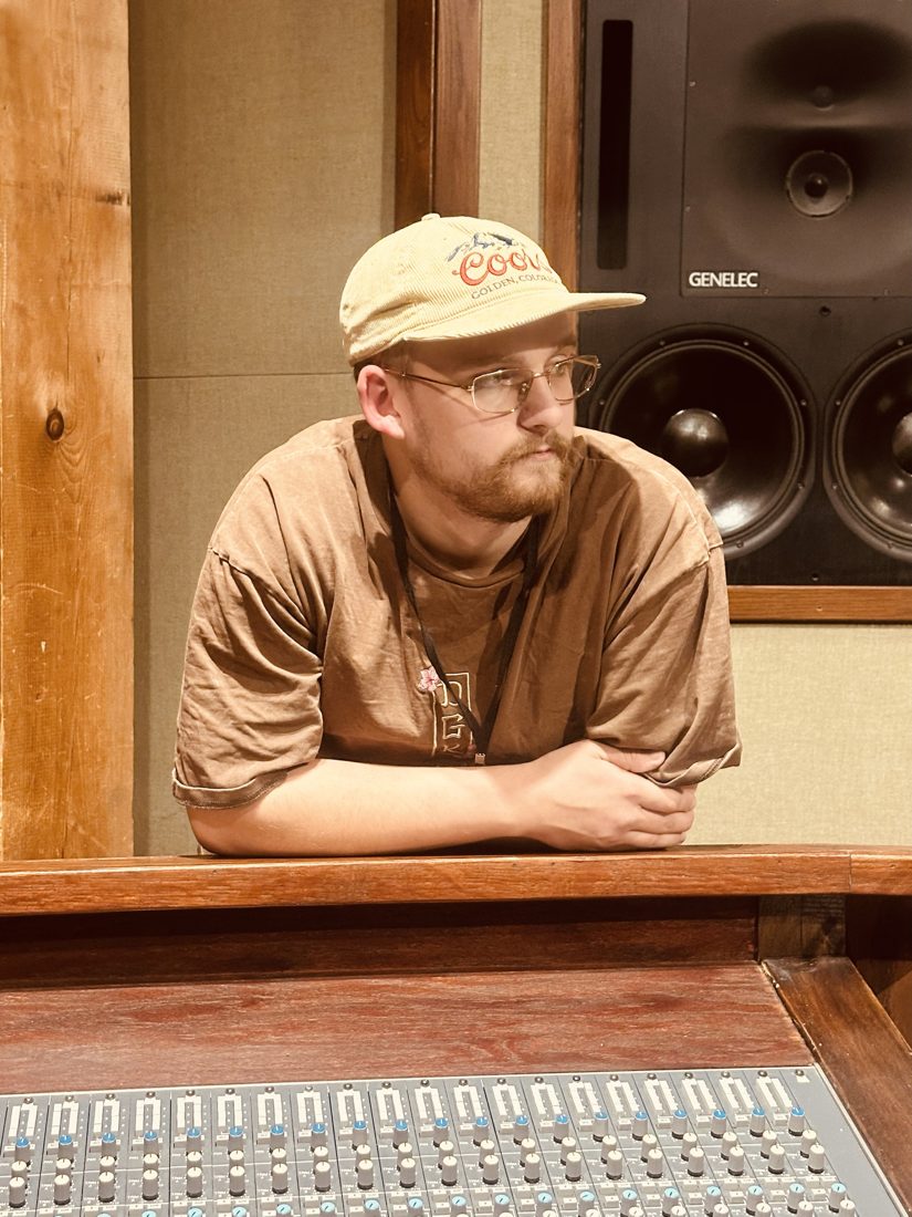 Thor Orri leaning on the console in front of studio monitors